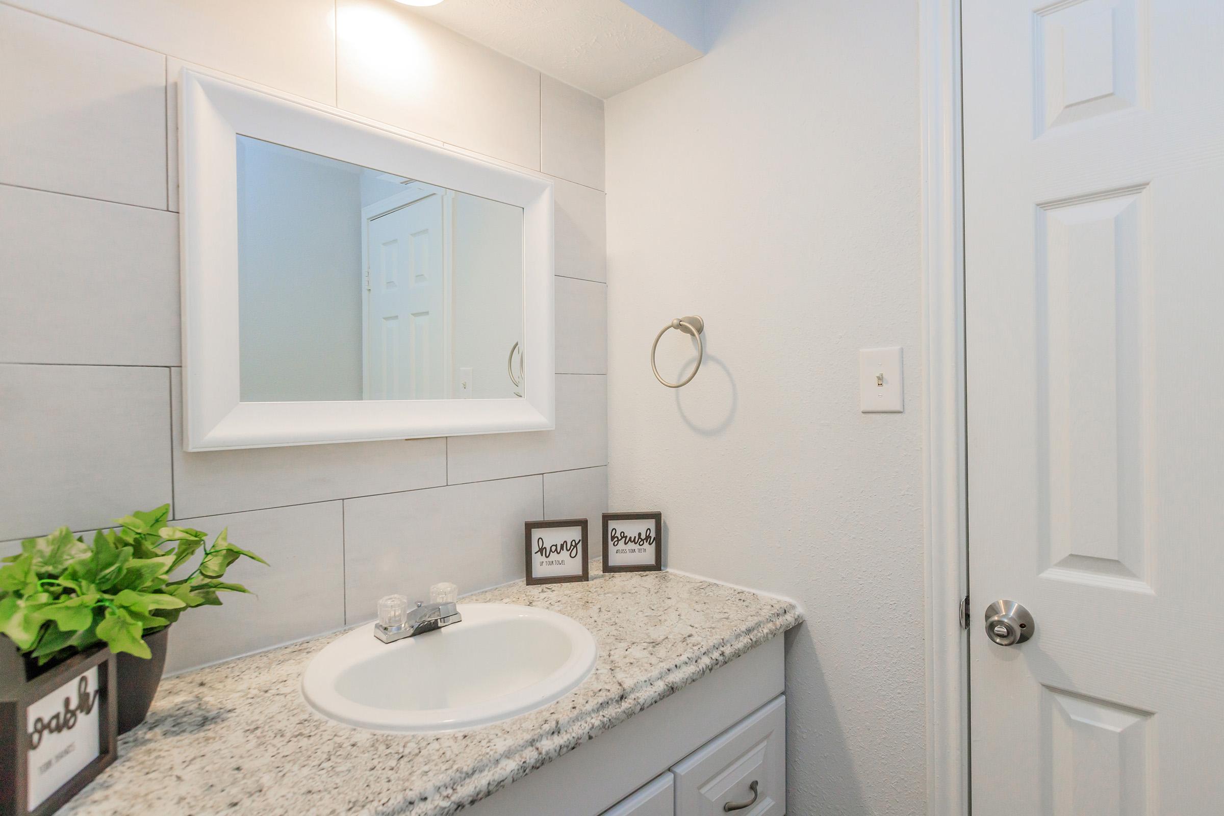 a kitchen with a sink and a mirror