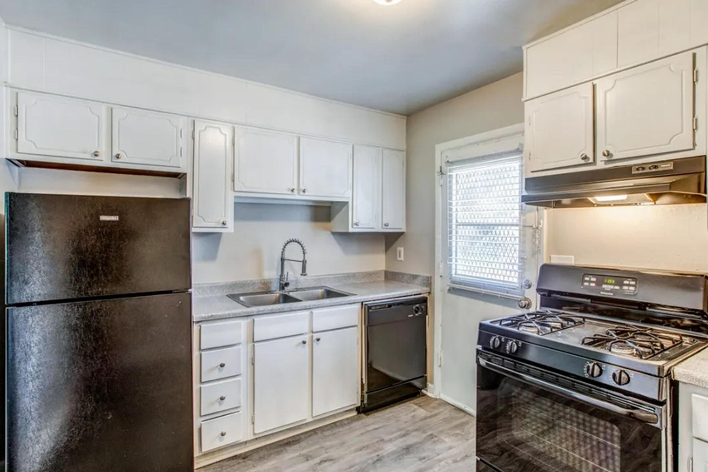 a stove top oven sitting inside of a kitchen