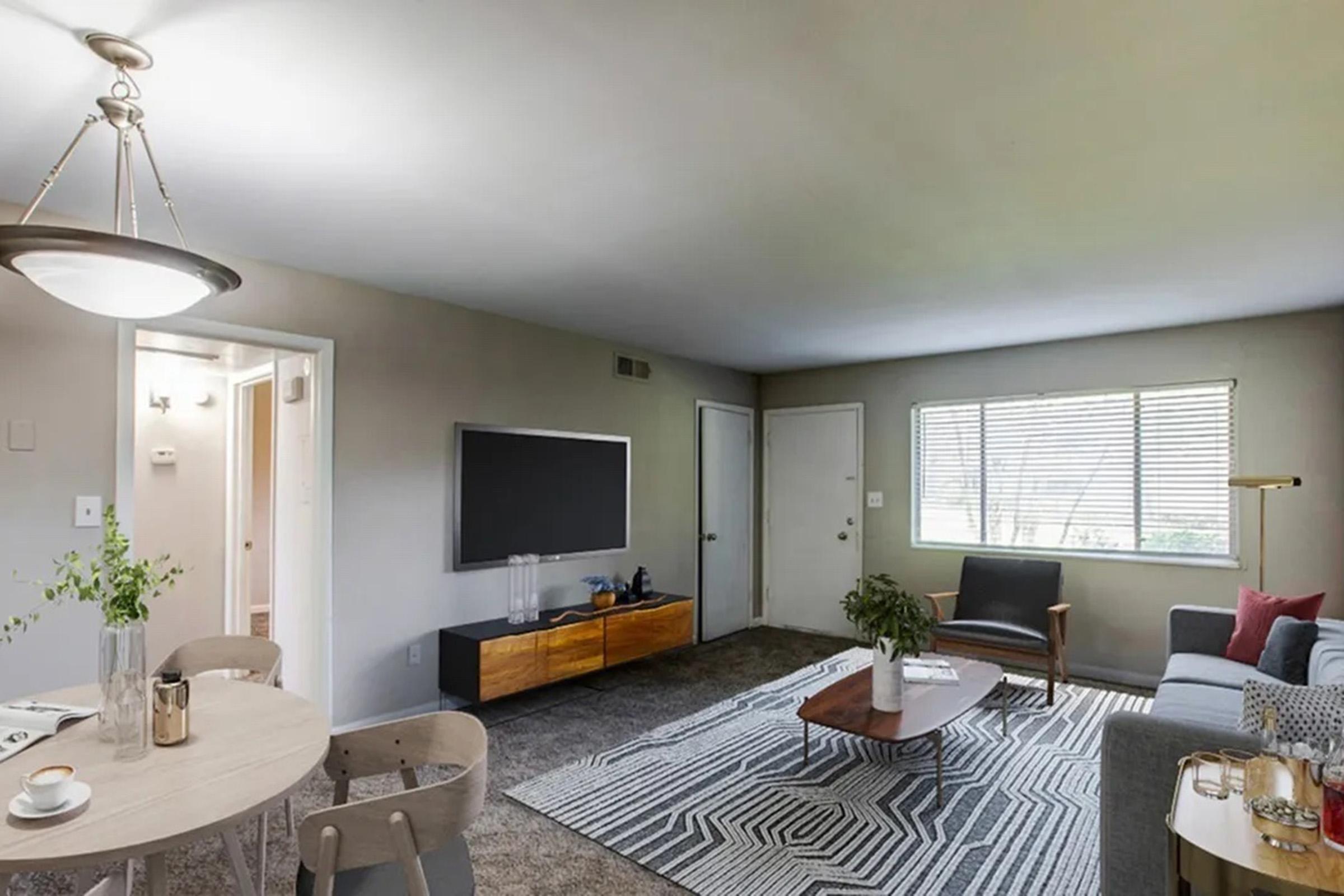 a living room filled with furniture and a sink