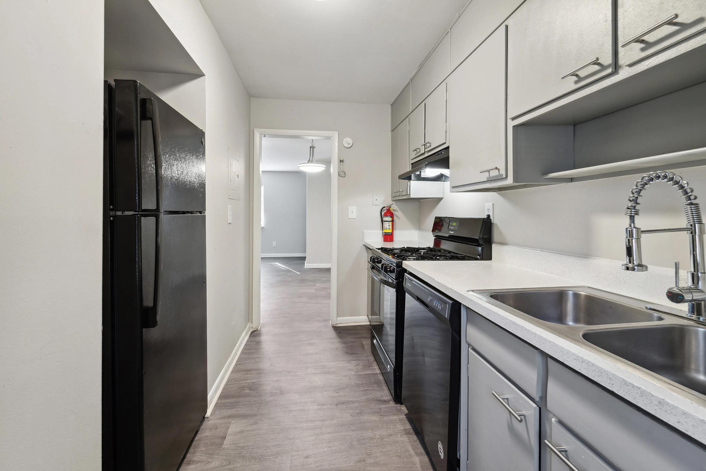 a kitchen with a sink and a mirror