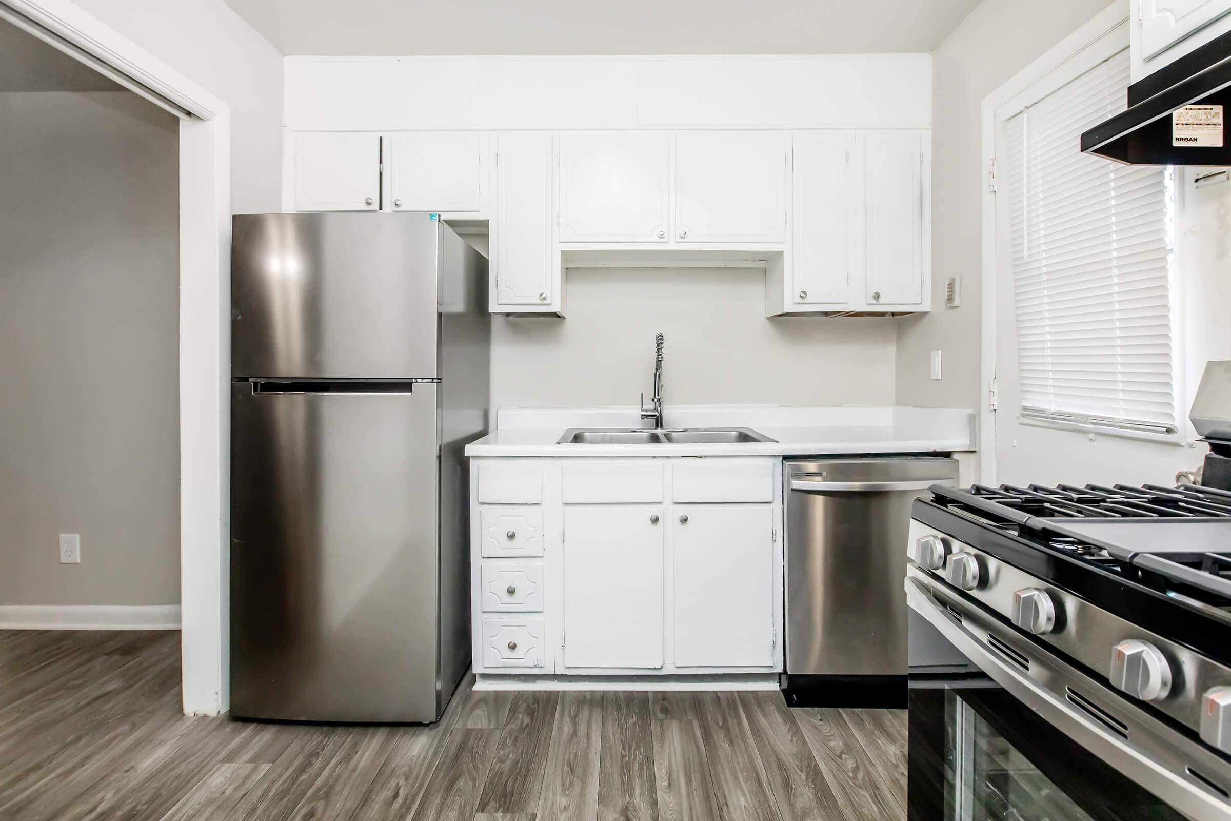 a stove top oven sitting inside of a kitchen