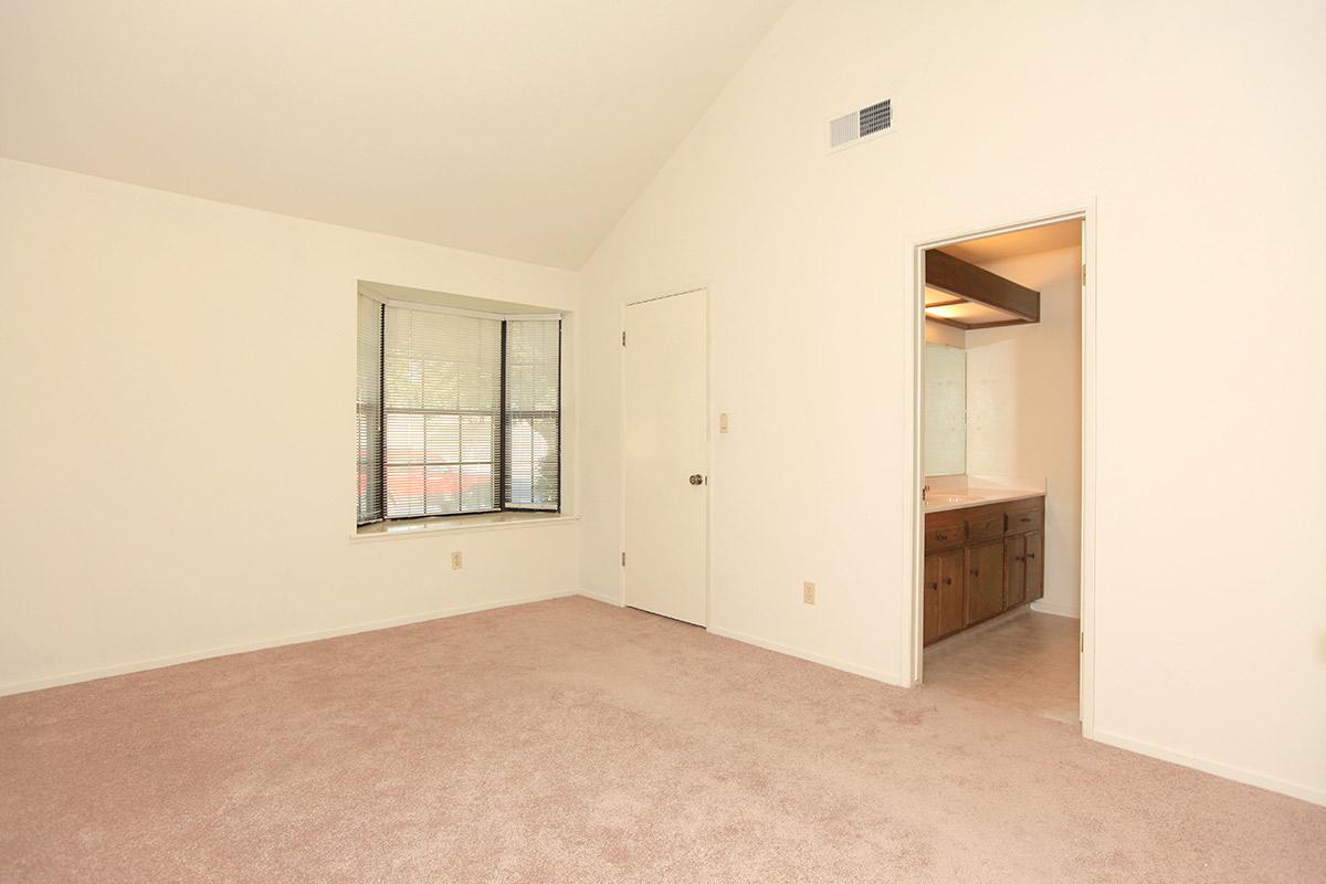 a bedroom with a wooden floor