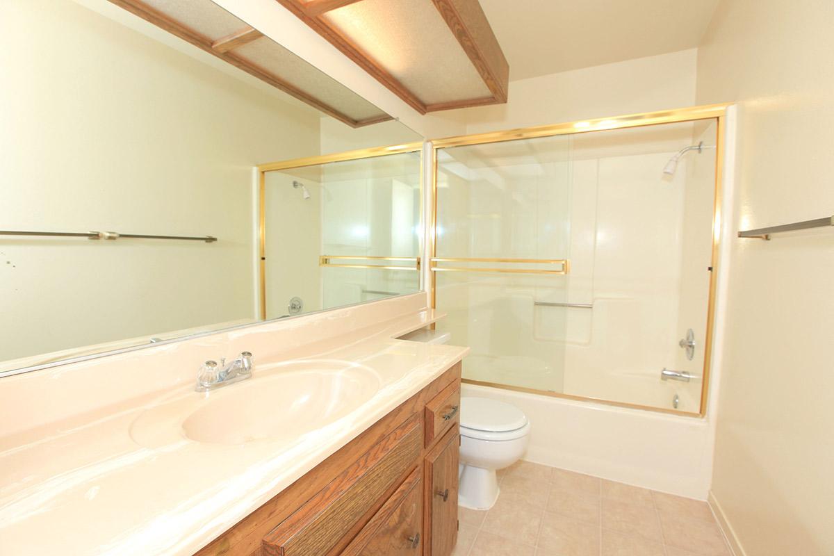 a white tub sitting next to a shower