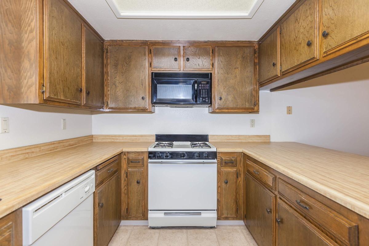 a stove top oven sitting inside of a kitchen