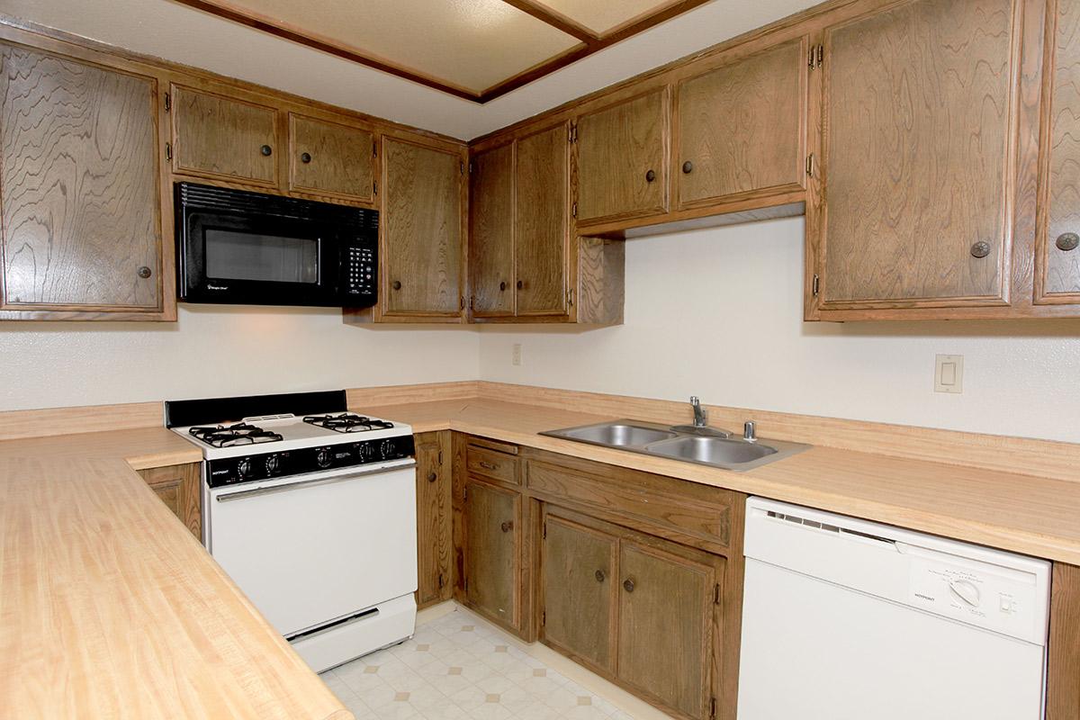 a stove top oven sitting inside of a kitchen