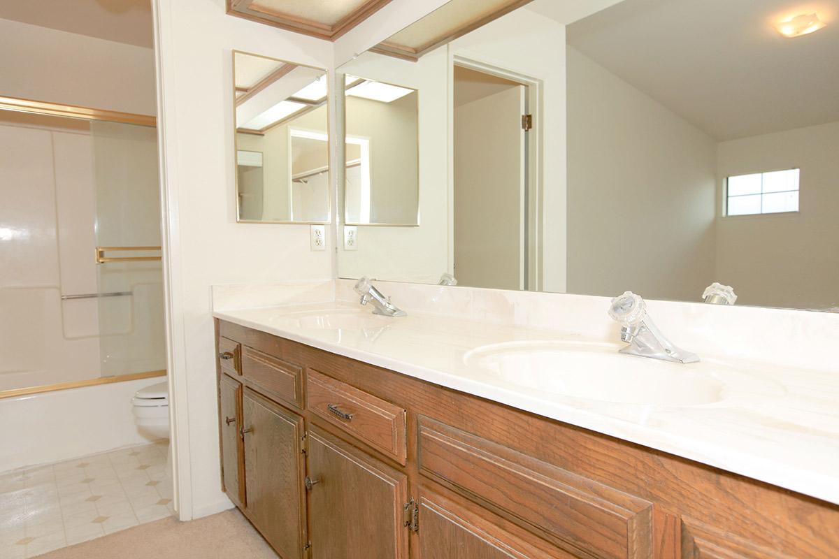 a large white tub next to a sink