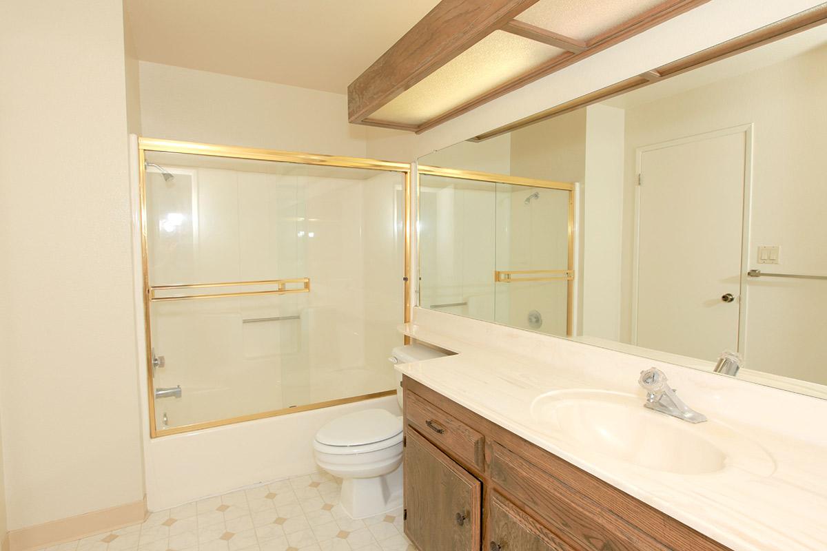 a large white tub next to a shower