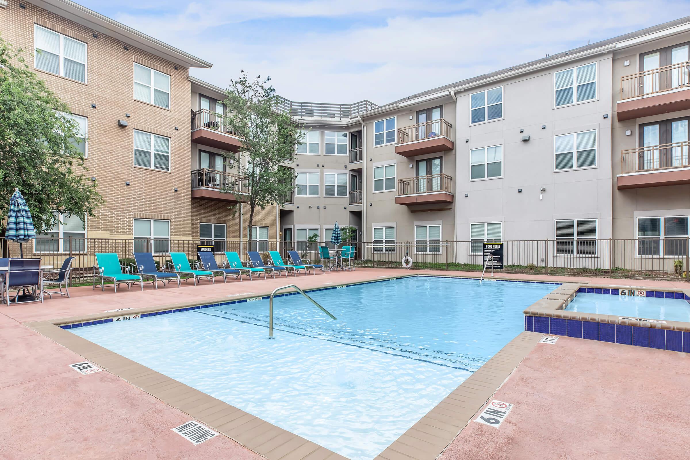 a person in a pool of water in front of a building