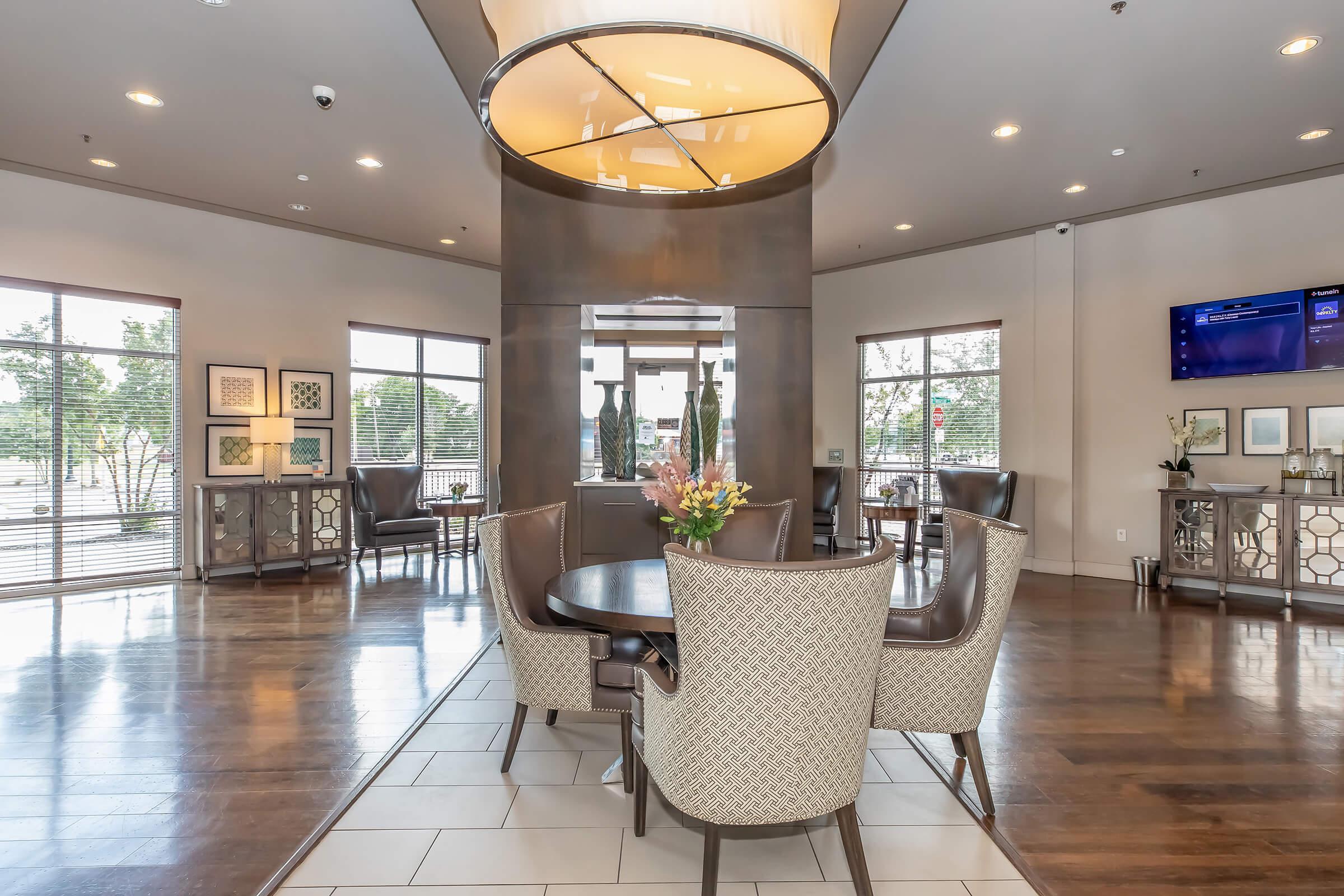 a living room filled with furniture and a large window