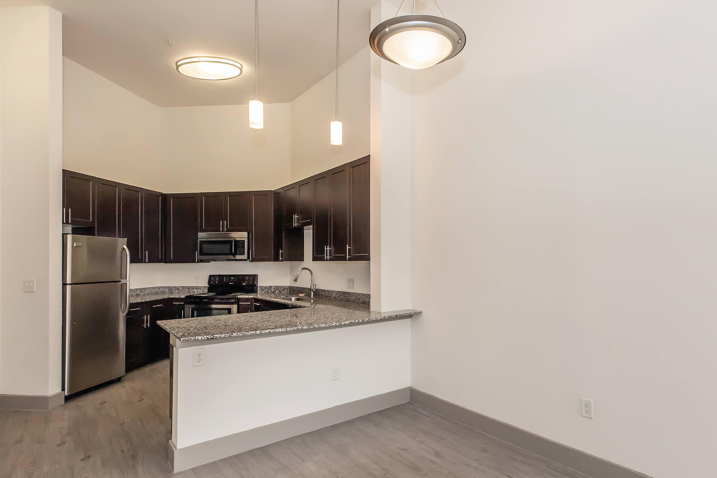 a kitchen with a sink and a mirror