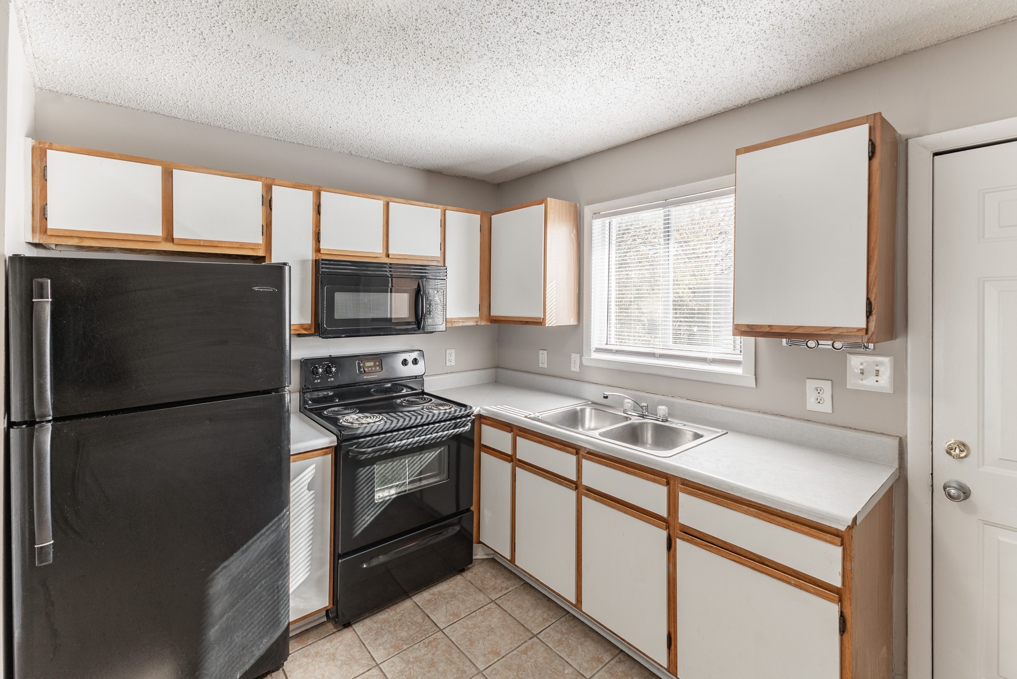 a kitchen with a stove a sink and a microwave