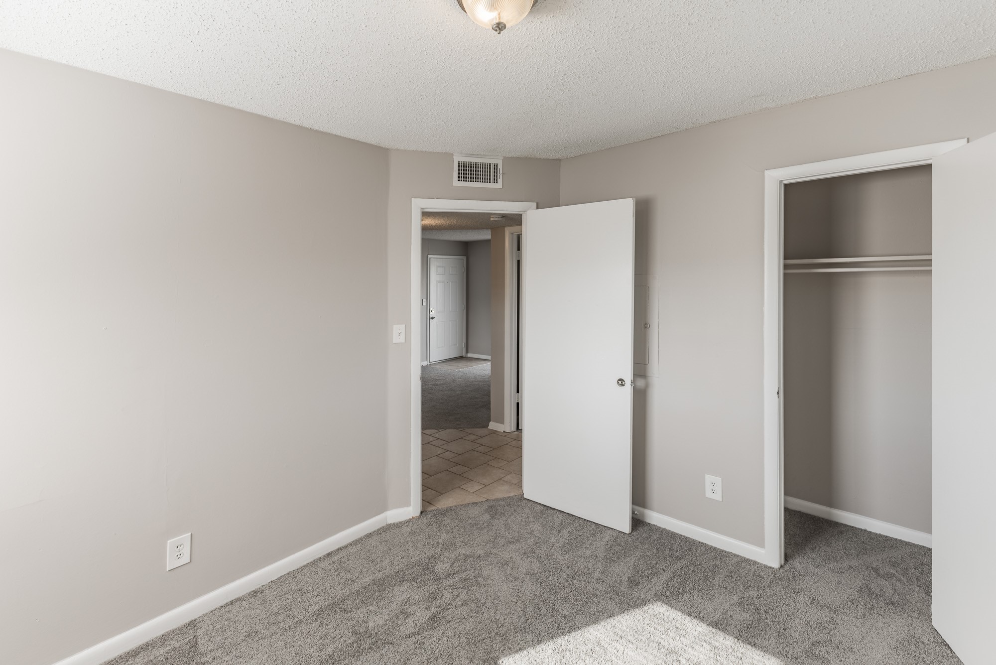 a large empty room with a sink and a mirror