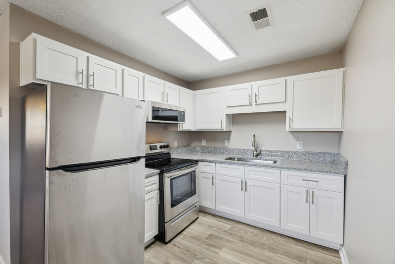 a kitchen with a stove and a refrigerator