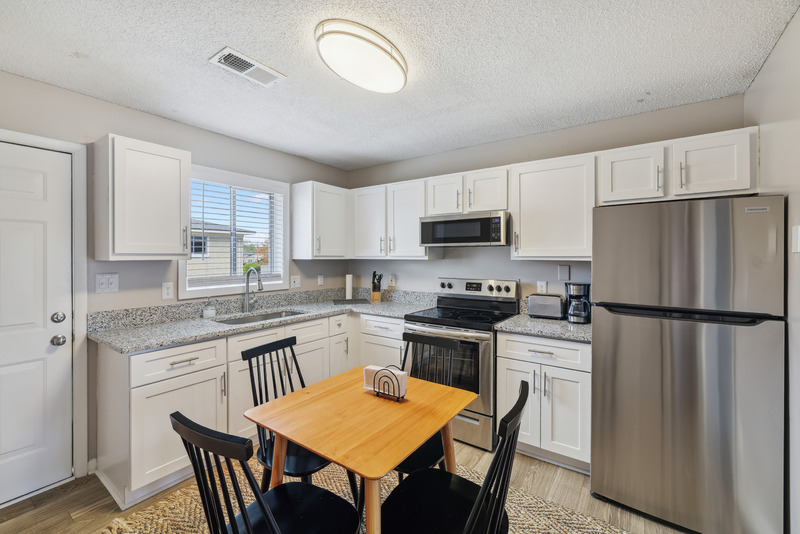 a modern kitchen with stainless steel appliances and wooden cabinets