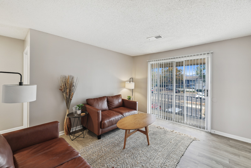 a living room filled with furniture and a large window