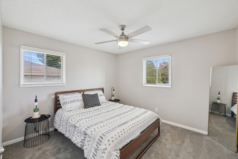 a bedroom with a bed and desk in a room