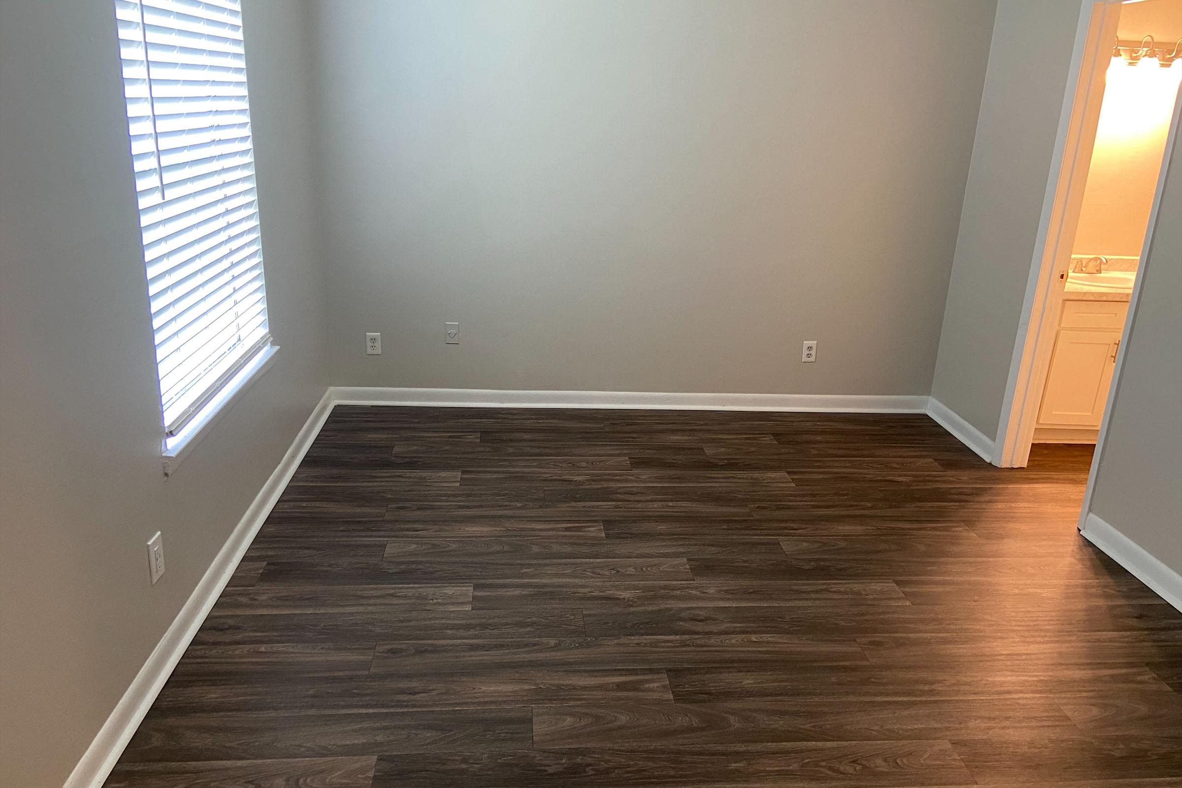 a laptop sits on top of a wooden floor