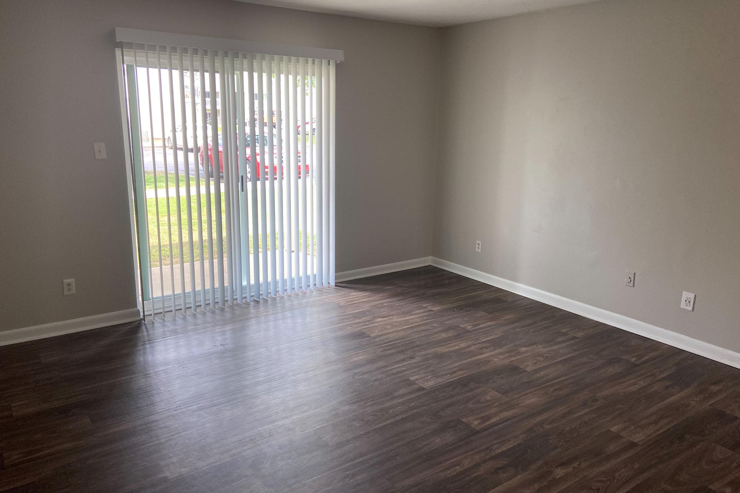 a large empty room with a wooden floor