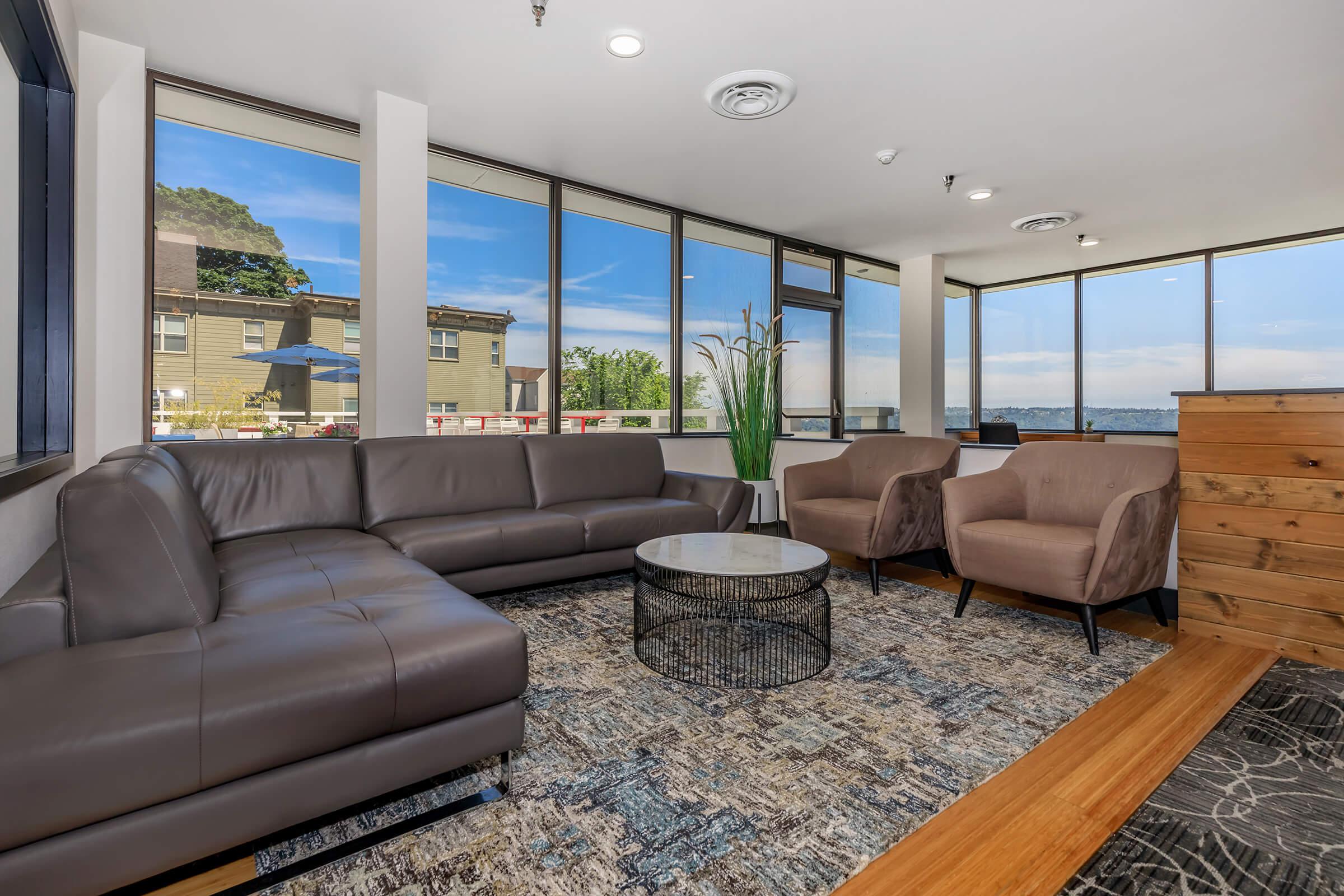 a living room filled with furniture and a large window