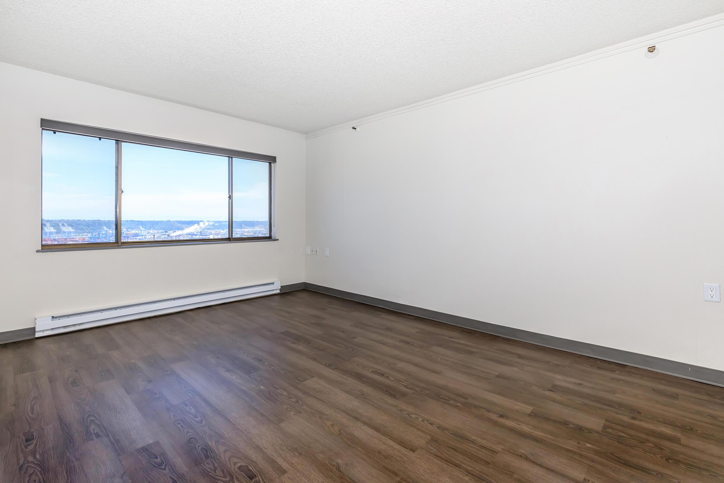 Apartments for Rent in Tacoma WA - Orion - Unfurnished Living Room with Wood-Style Flooring and Large Window