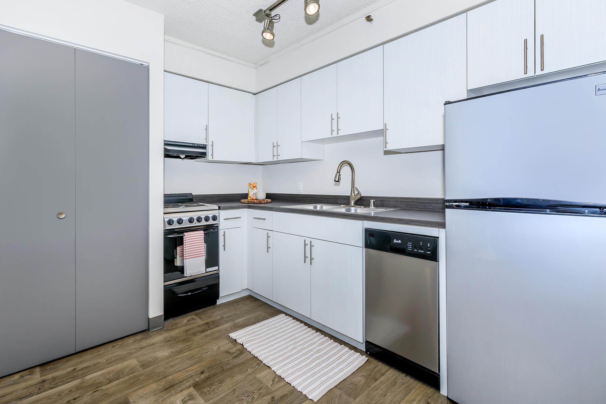 a kitchen with a sink and a refrigerator