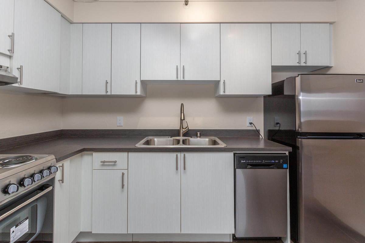 a stove top oven sitting inside of a kitchen
