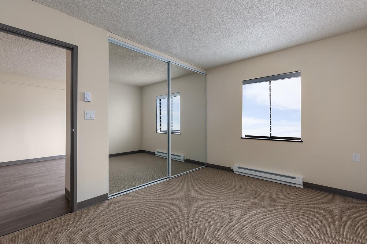 a bedroom with a bed in a room