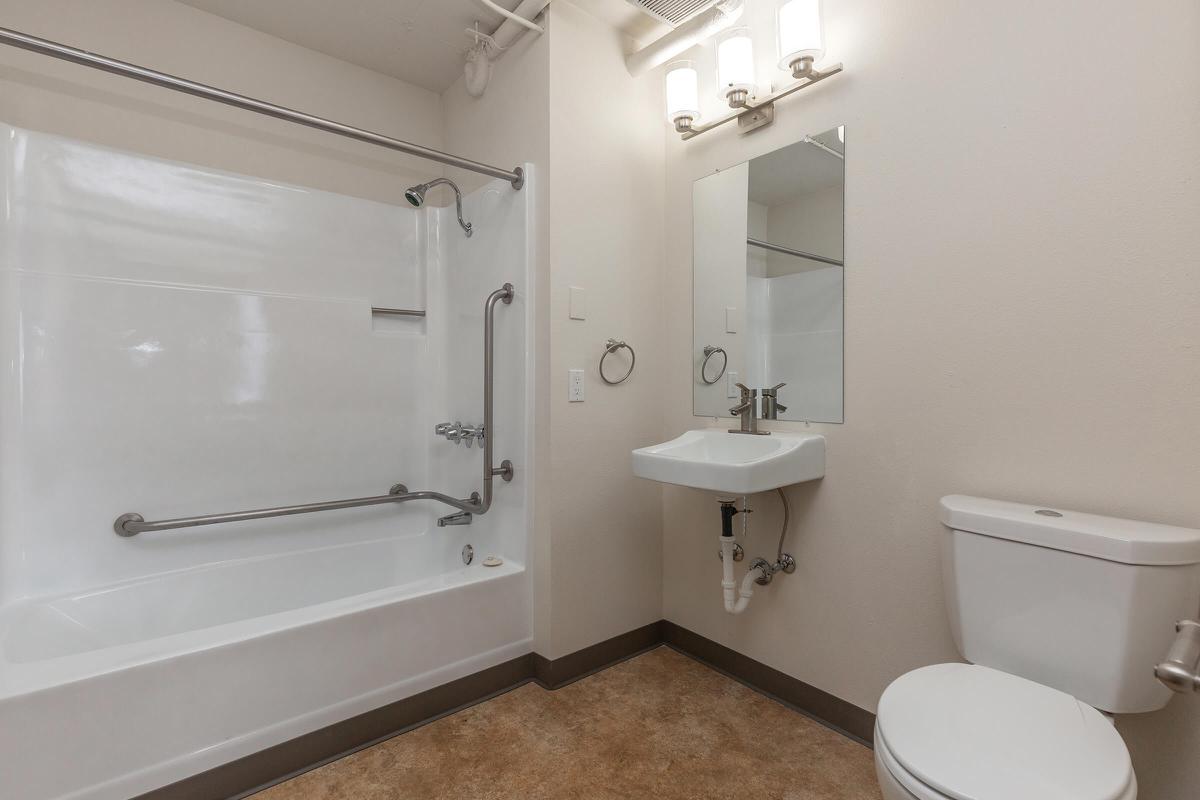 a white sink sitting next to a shower
