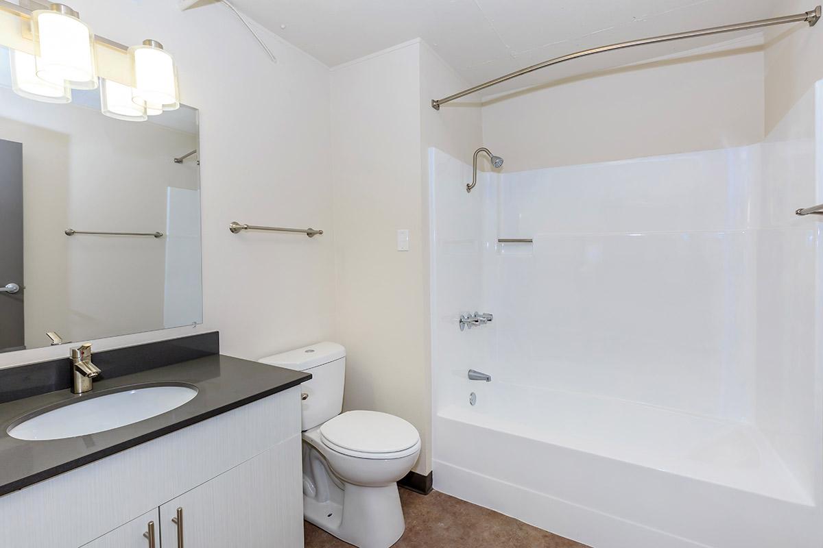 a large white tub sitting next to a sink