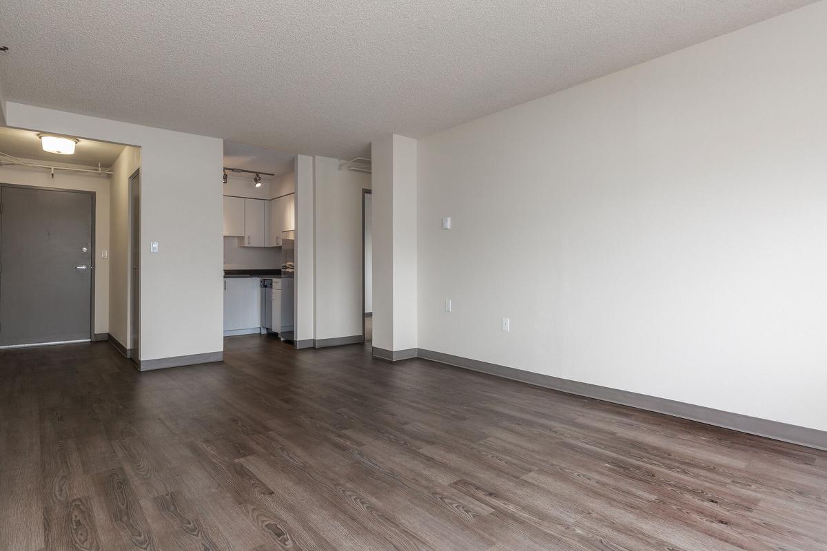 a large empty room with a wood floor