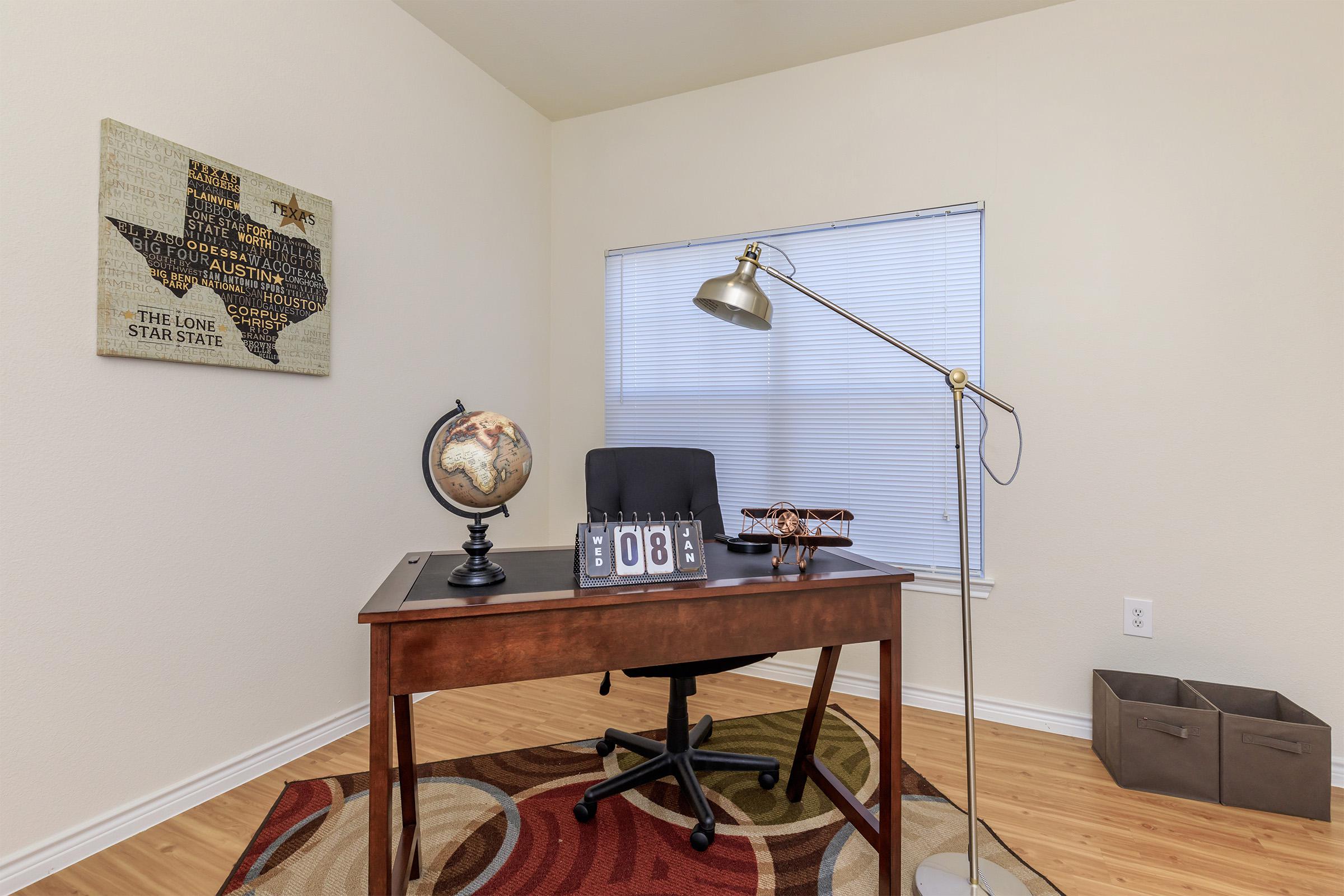 a bedroom with a desk and chair in a room