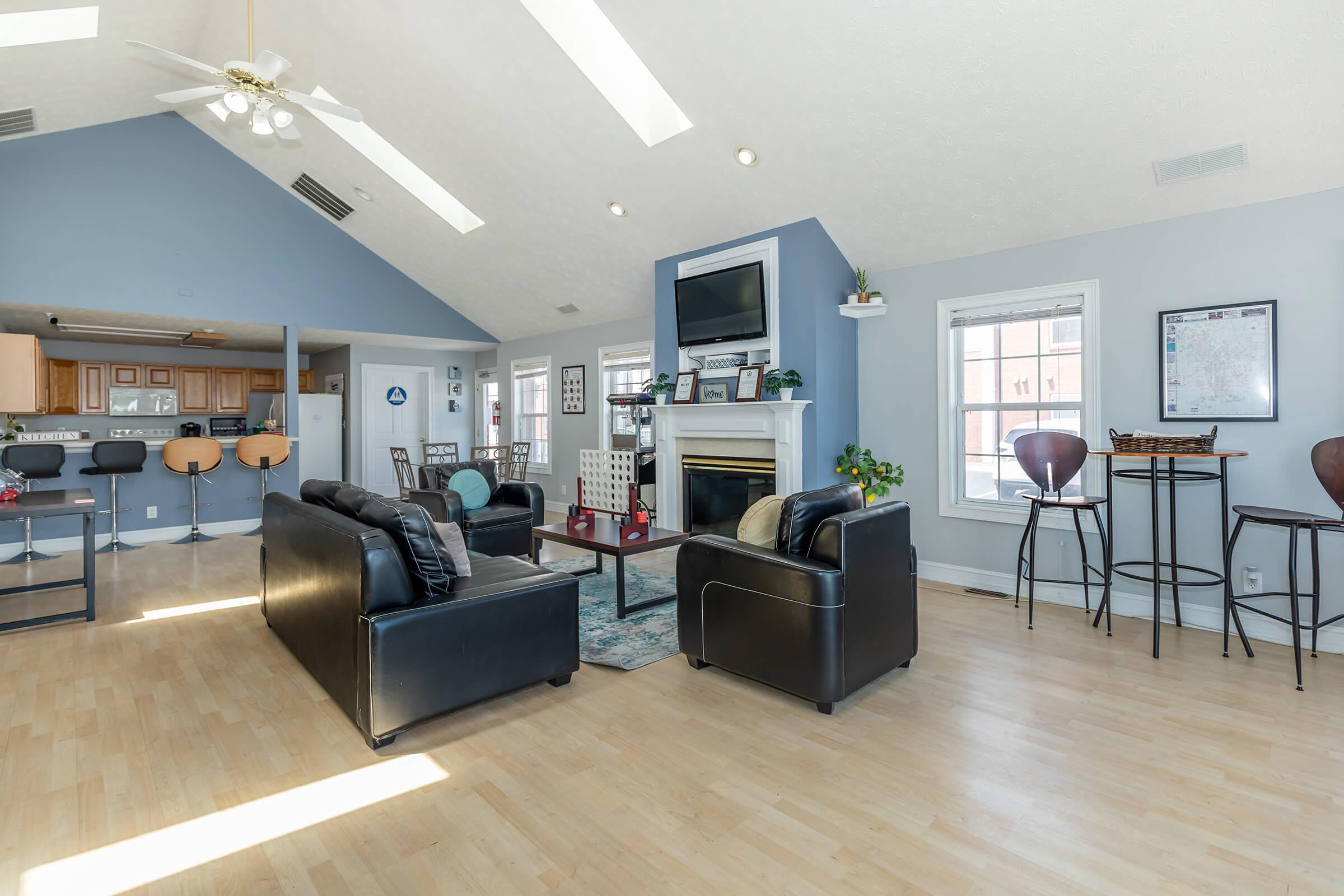 a living room filled with furniture and a wood floor