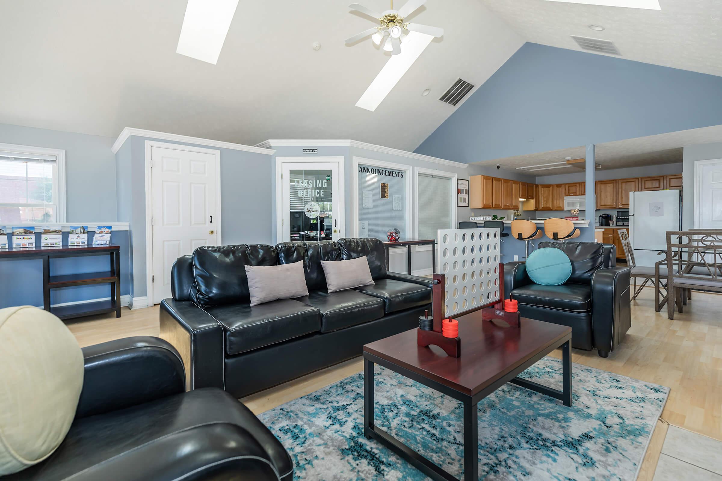 a living room filled with furniture and a large window