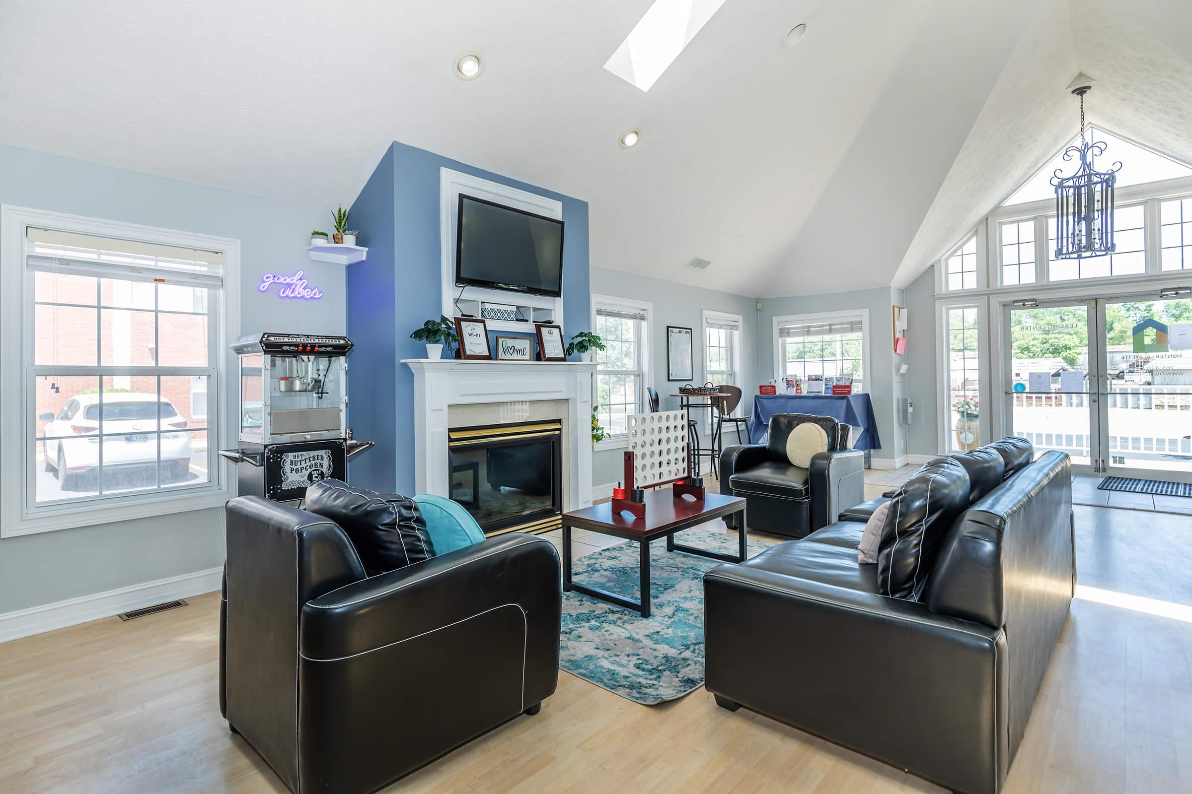 a living room filled with furniture and a large window