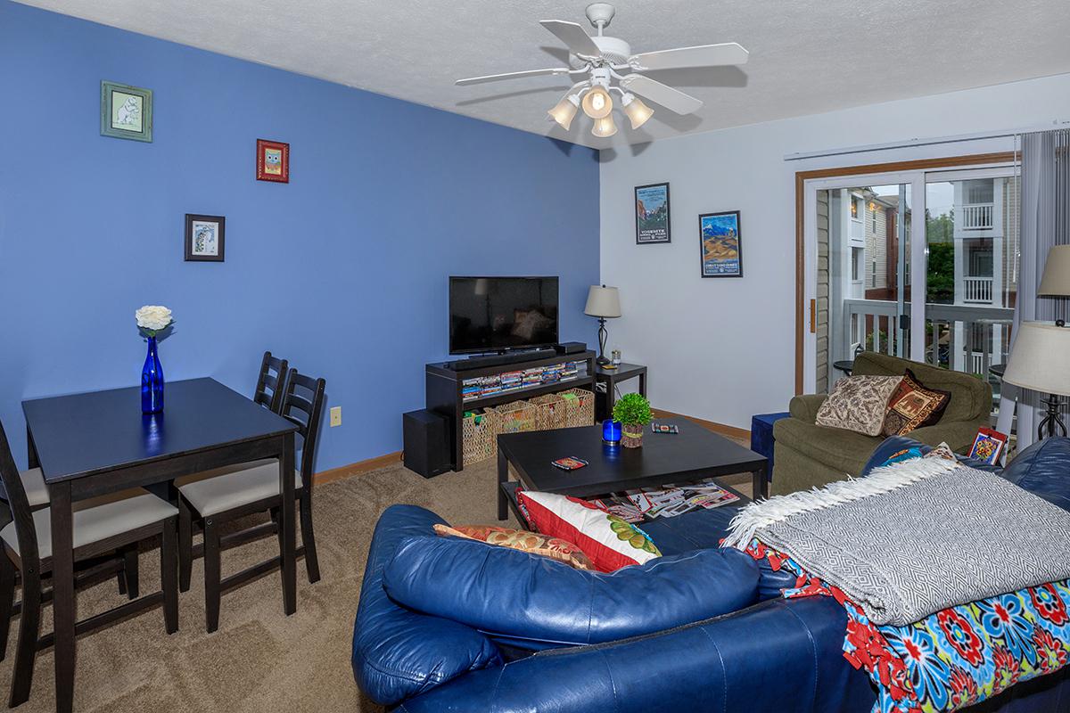 a living room filled with furniture and a large window