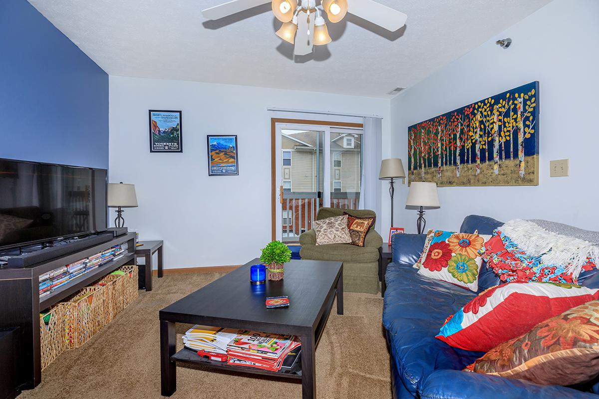 a living room filled with furniture and a flat screen tv