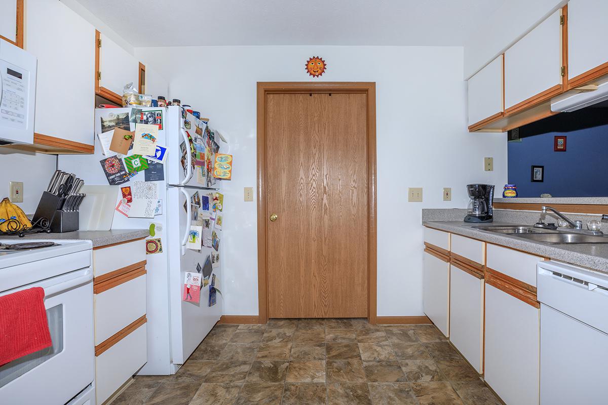 a kitchen with a stove sink and refrigerator