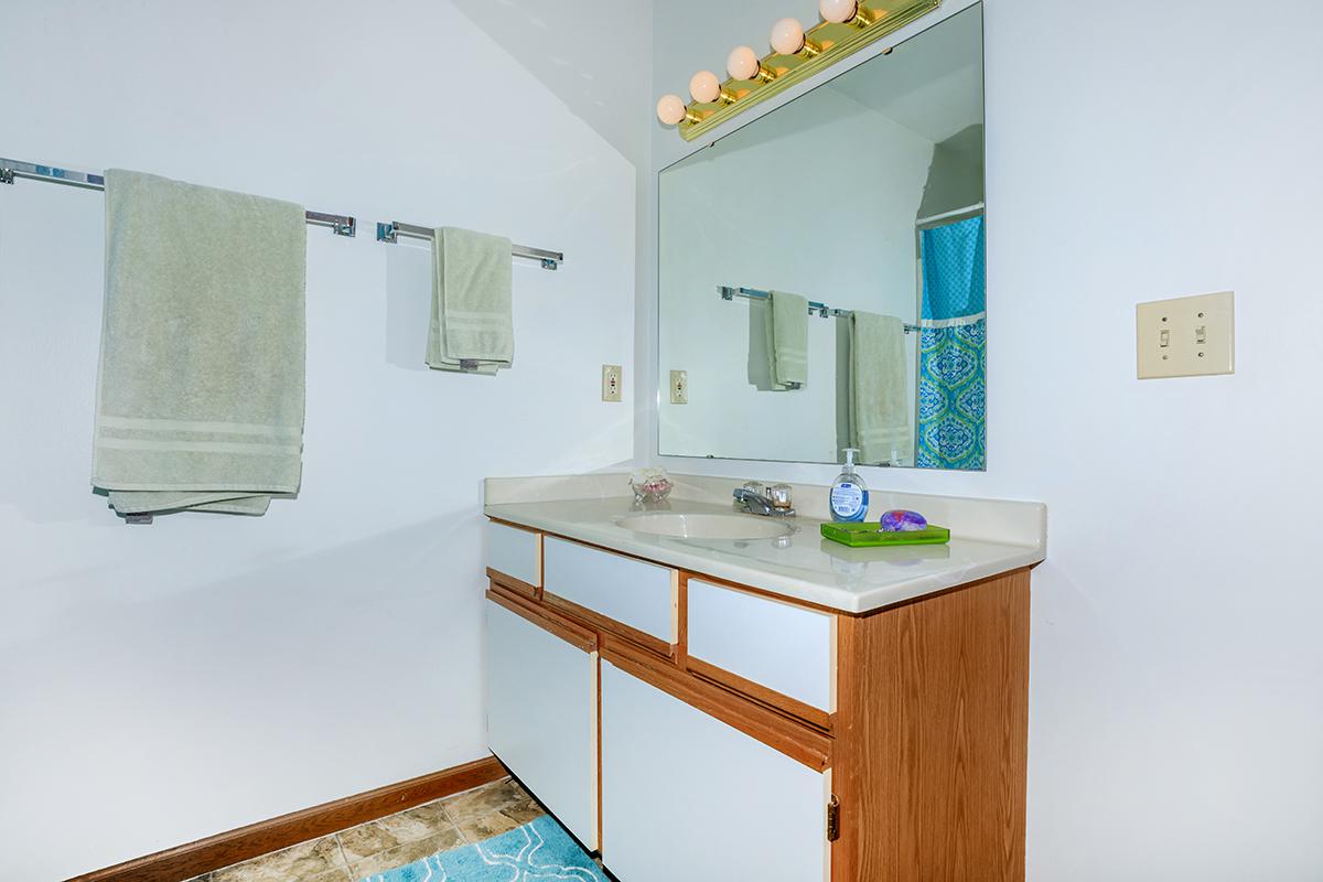 a kitchen with a sink and a mirror