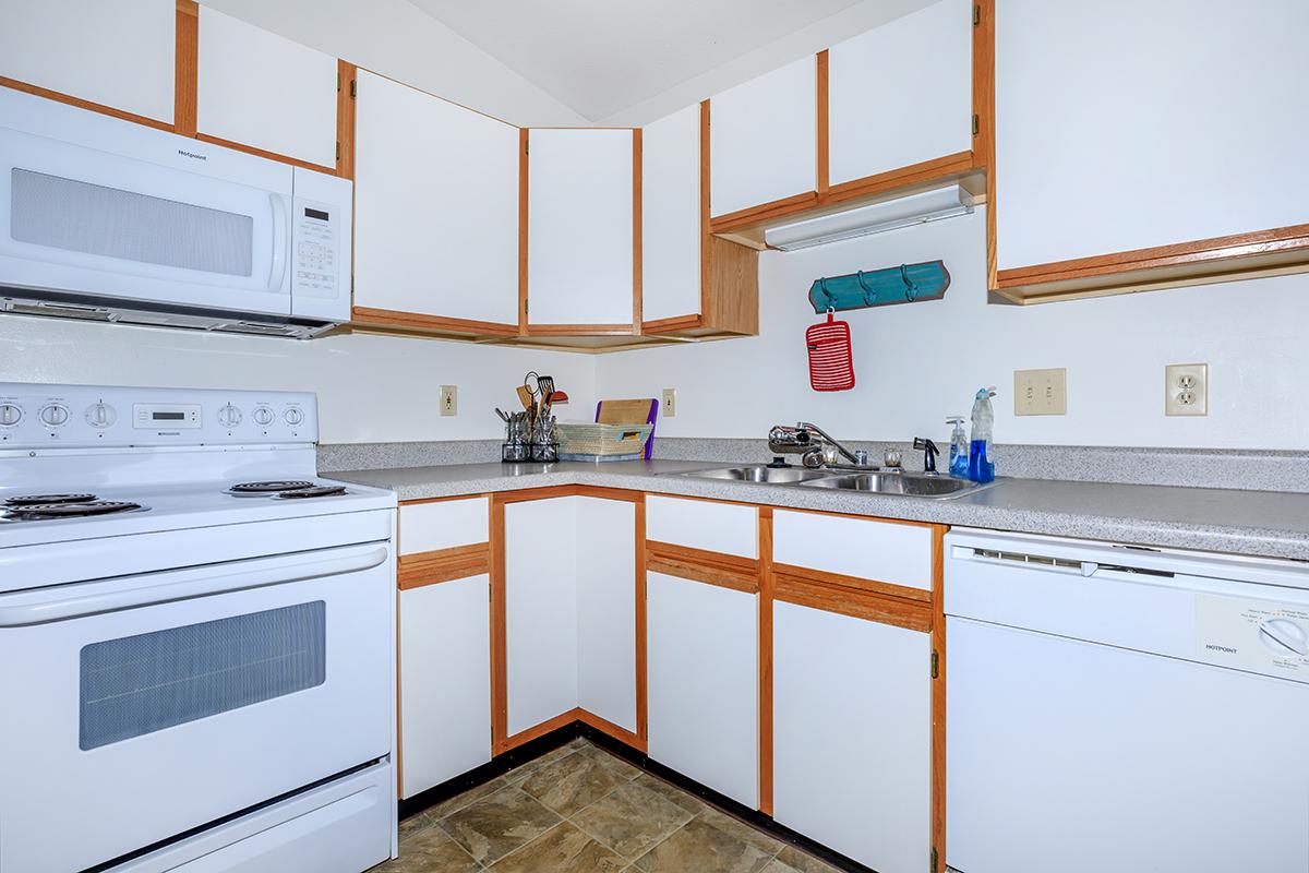 a stove top oven sitting inside of a kitchen