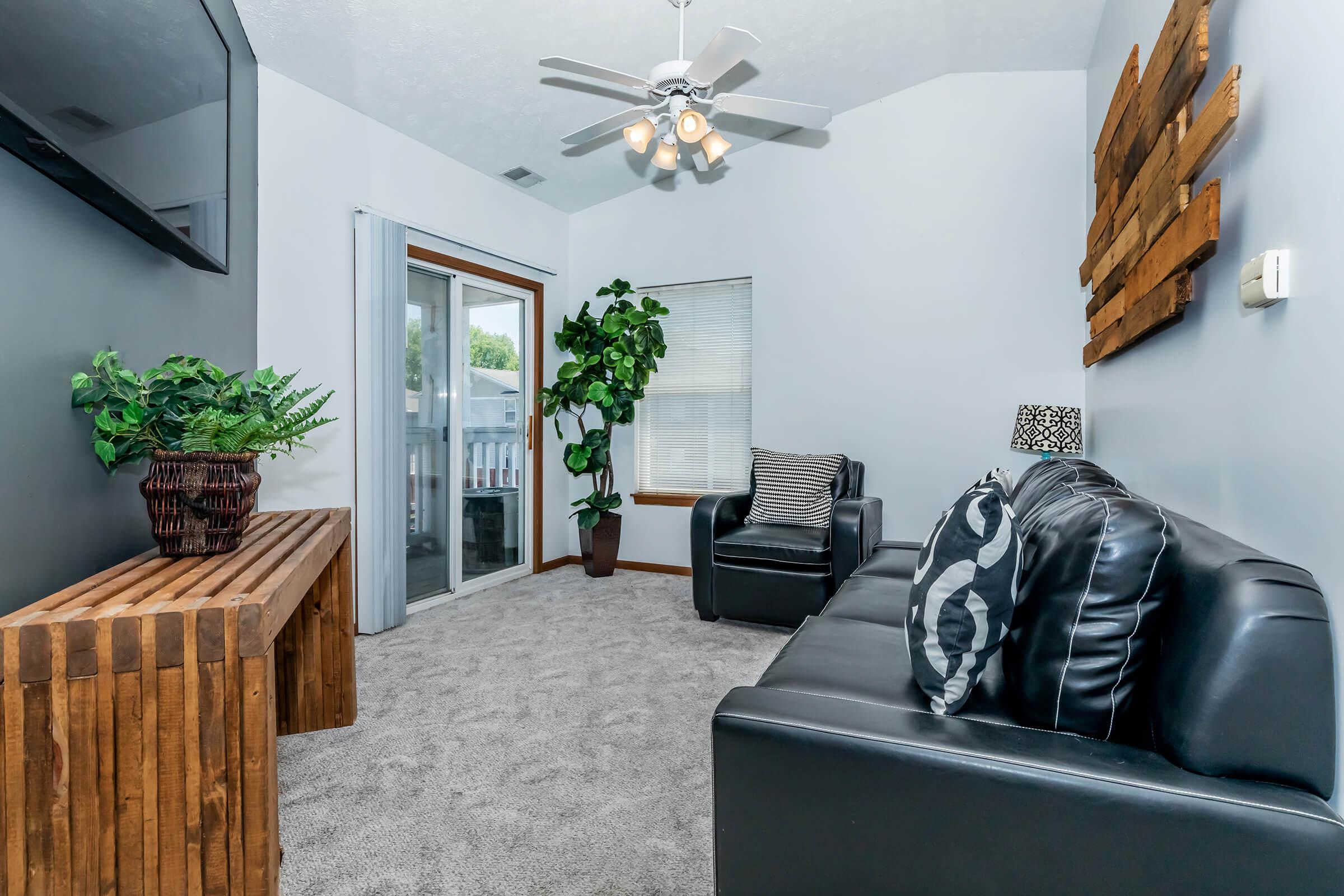 a living room filled with furniture and a tv