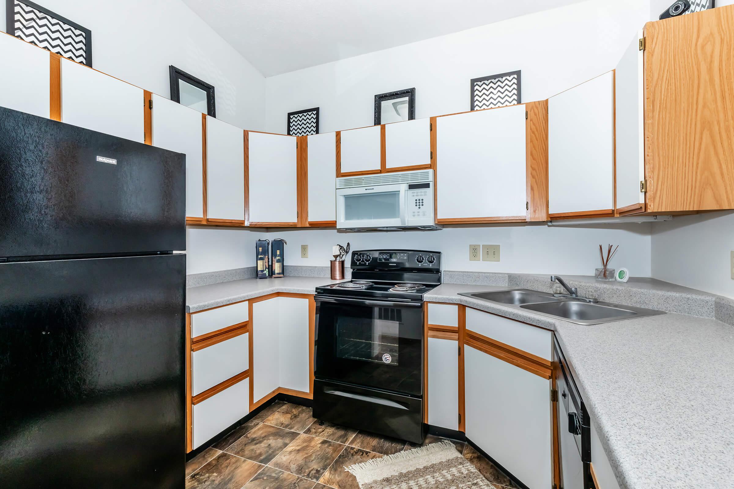 a kitchen with stainless steel appliances and wooden cabinets