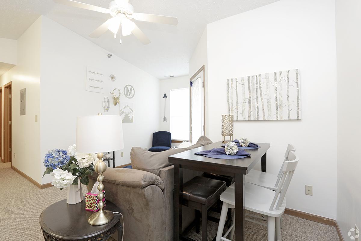 a living room filled with furniture and a table