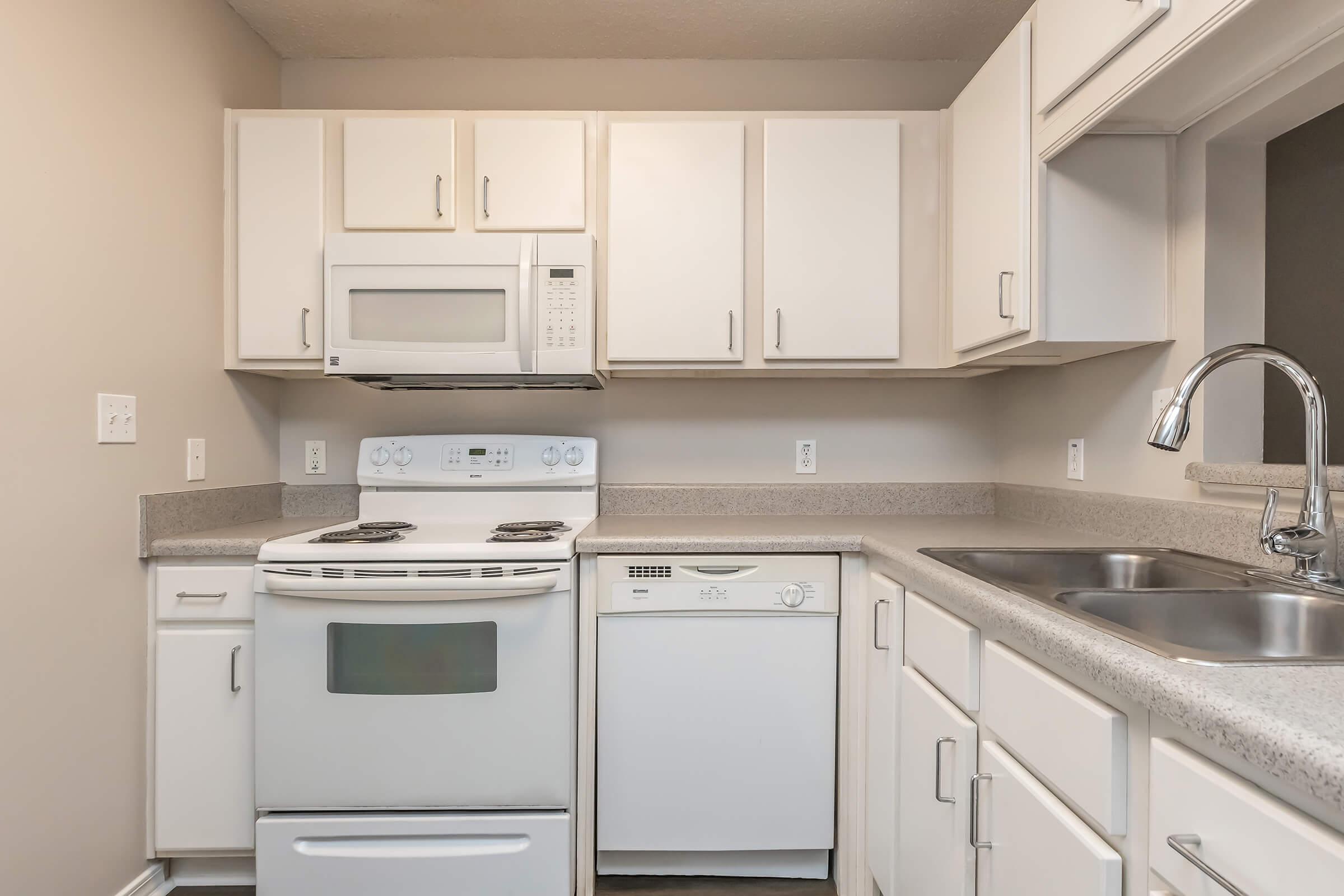 a stove top oven sitting inside of a kitchen