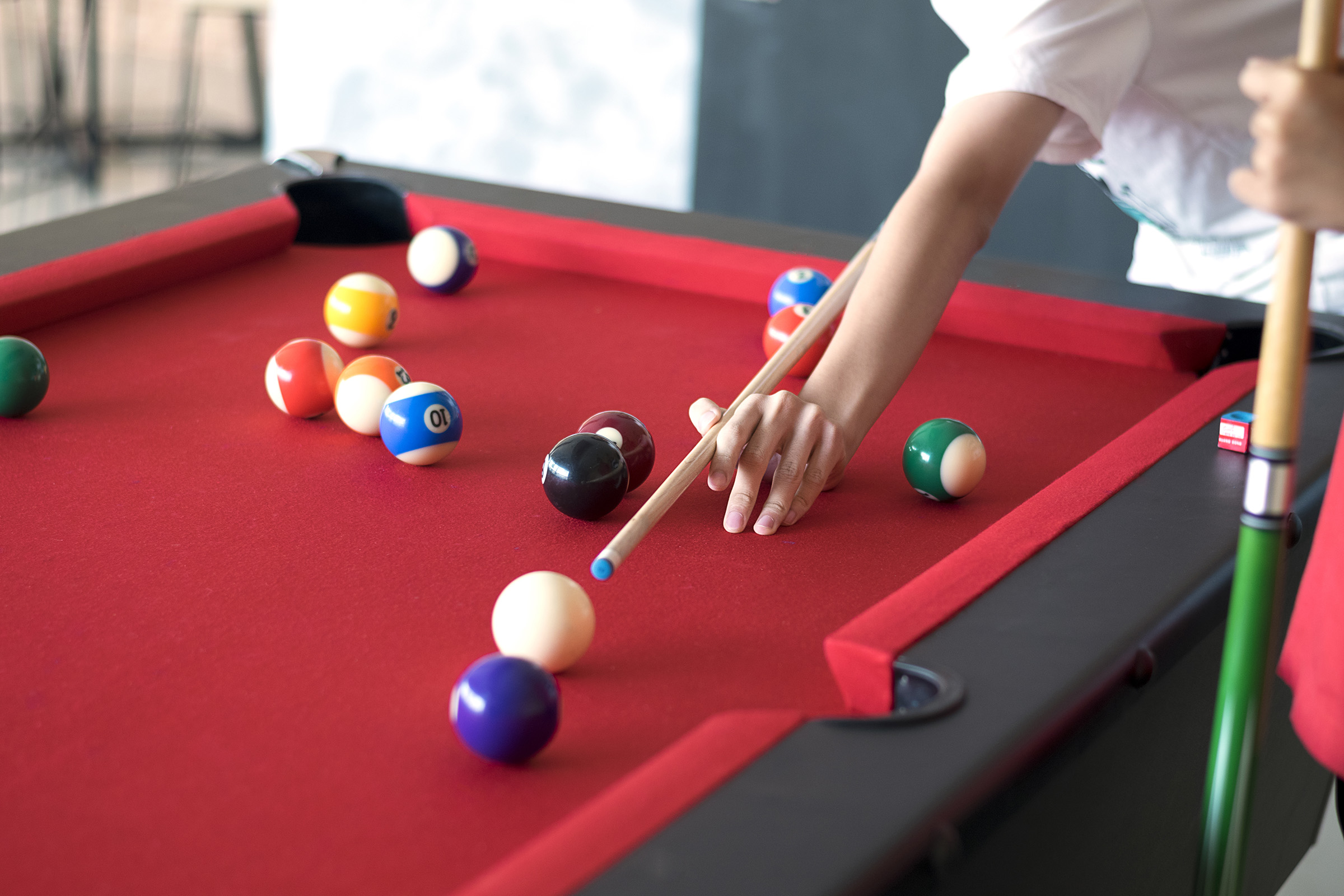 a person sitting at a table with a blue ball