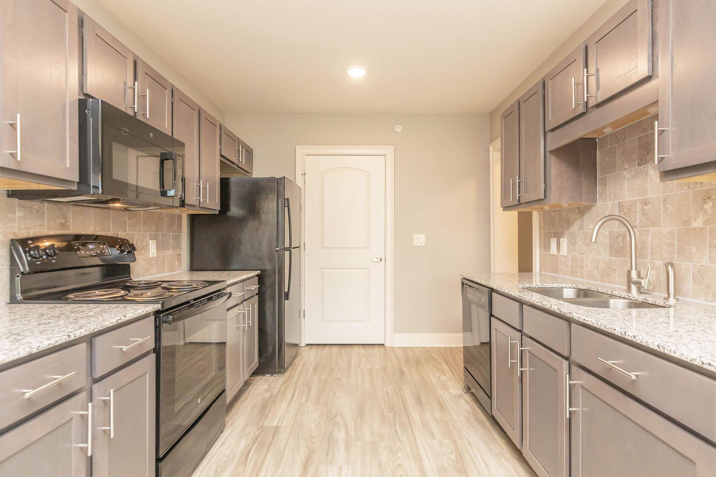 a large kitchen with stainless steel appliances