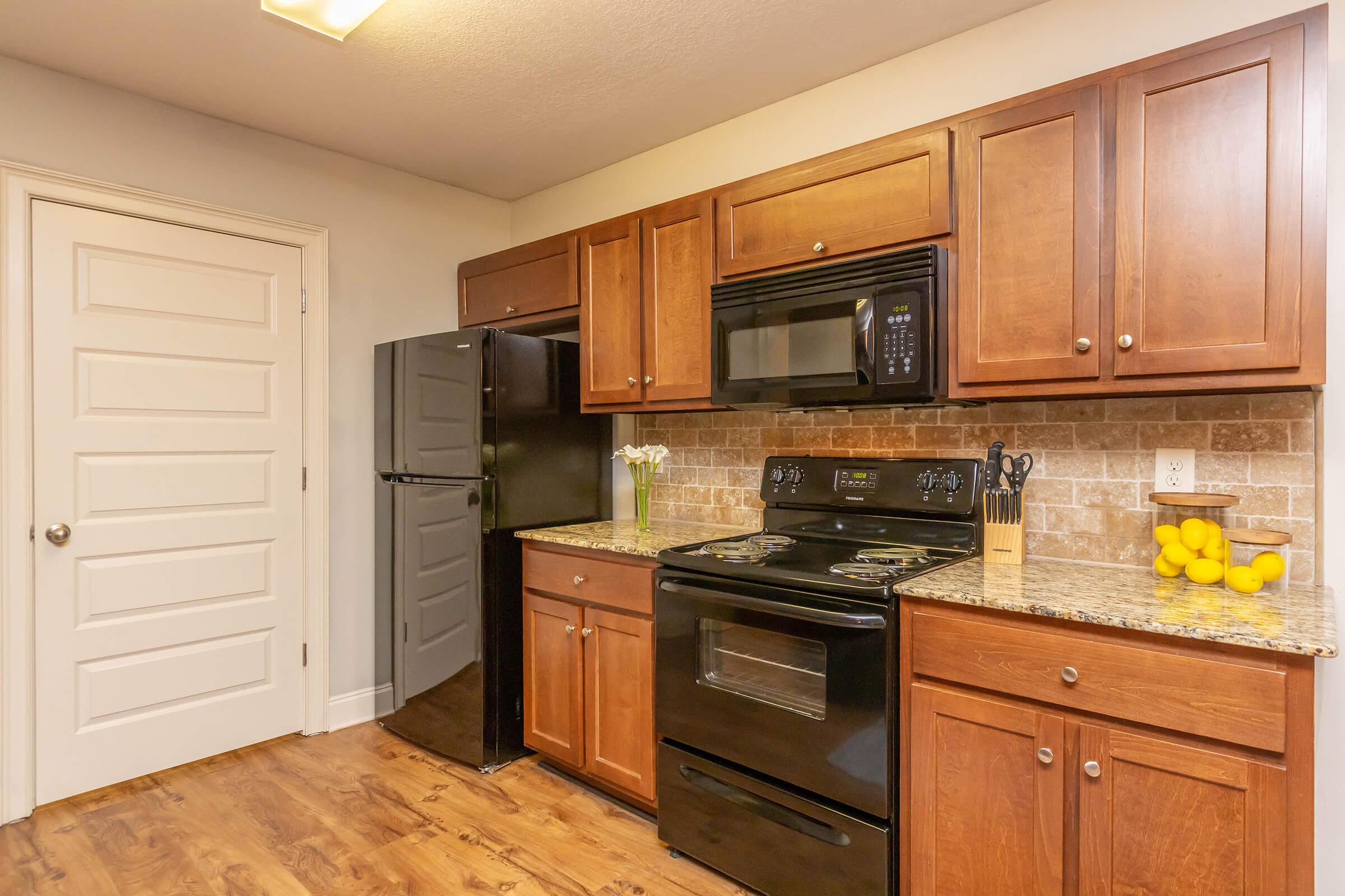 a kitchen with stainless steel appliances and wooden cabinets