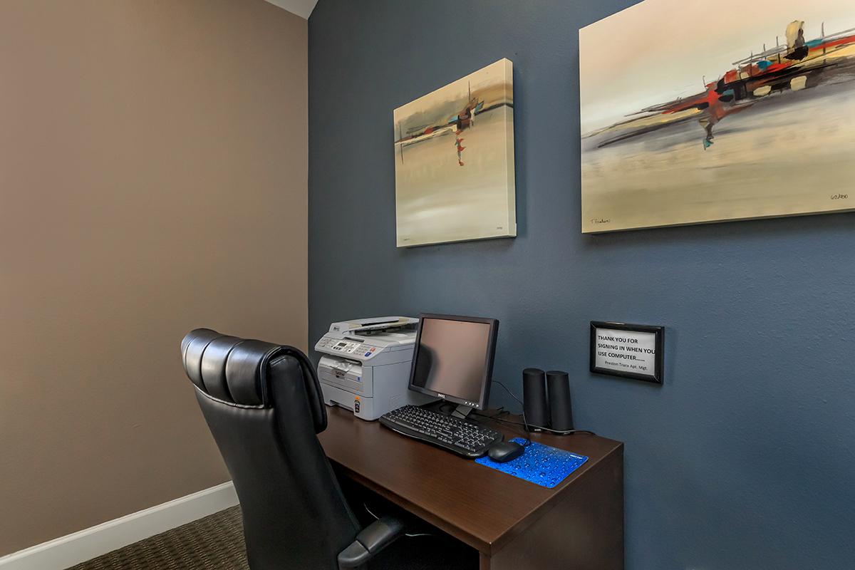 a desk with a computer on a table