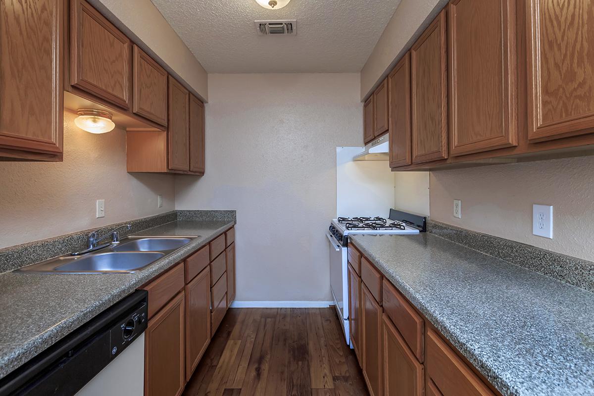 a kitchen with stainless steel appliances and wooden cabinets