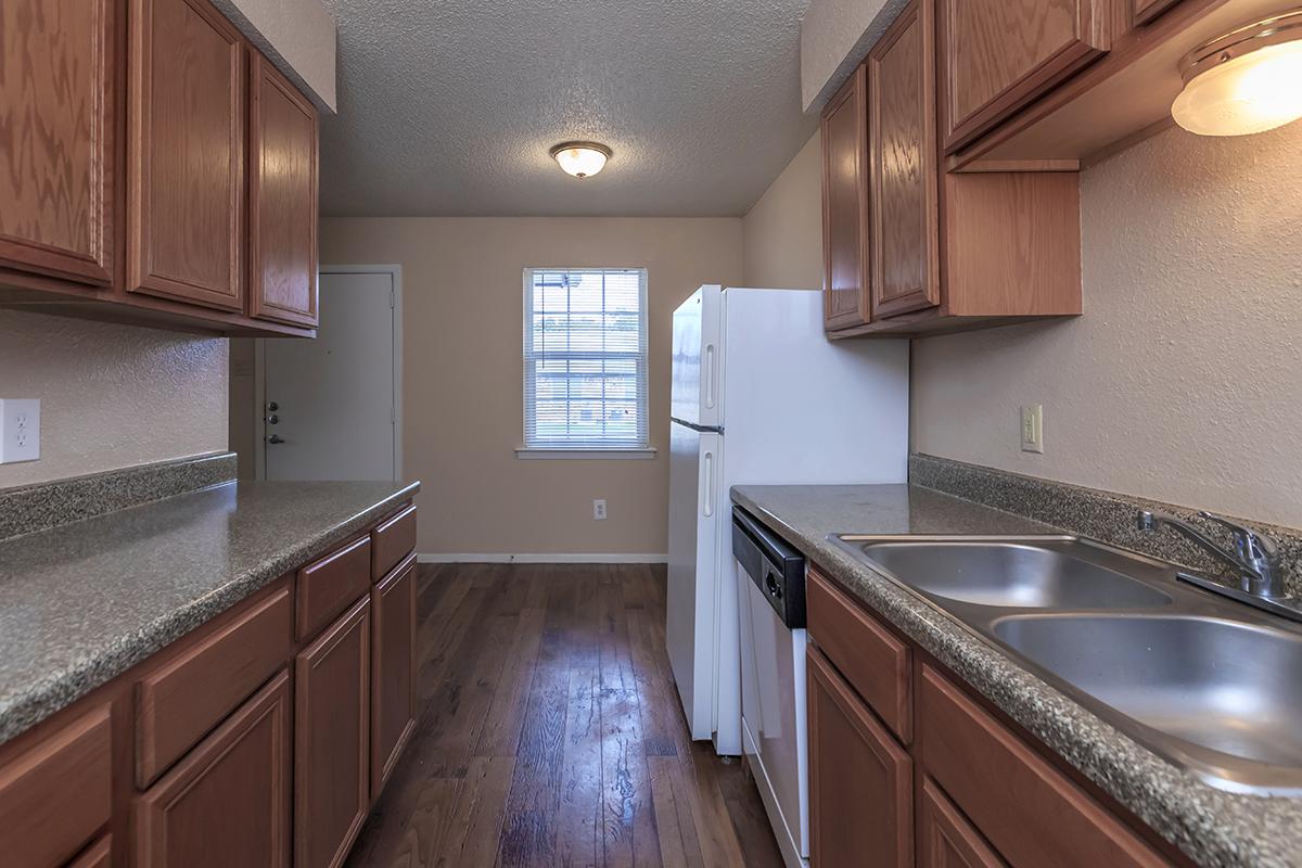 a kitchen with stainless steel appliances and wooden cabinets