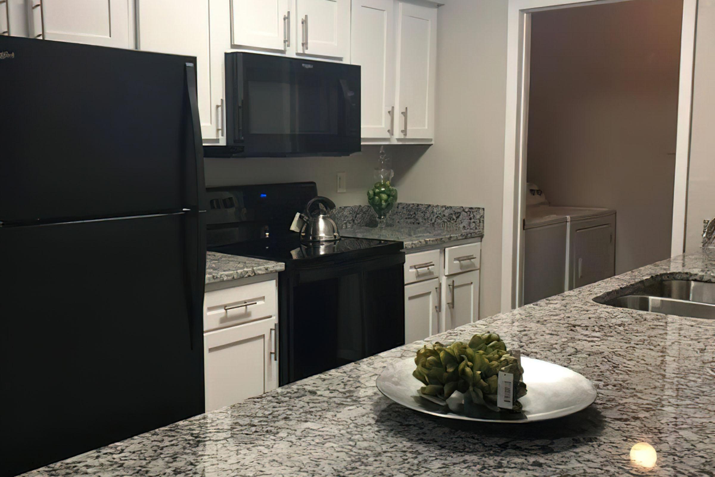 a vase of flowers on a kitchen counter